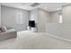 Open living space with neutral walls, carpet, television and cabinet for entertainment at 15 Santo Mio Ct, Henderson, NV 89011