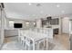 Open-concept living space with a large kitchen island, a dining table for eight, and a comfortable seating area at 15 Santo Mio Ct, Henderson, NV 89011