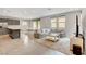 Open-concept living room with stainless steel appliances and a cozy, gray sectional sofa at 15 Santo Mio Ct, Henderson, NV 89011