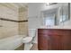 Updated bathroom featuring tile walls, a tub, and modern vanity with neutral countertop at 1550 Jamielinn Ln # 102, Las Vegas, NV 89110