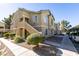 Exterior angle shot of a two-story condominium with desert landscaping at 1550 Jamielinn Ln # 102, Las Vegas, NV 89110