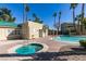 Exterior shot of hot tub area, and pool, with desert landscaping and nearby clubhouse at 1550 Jamielinn Ln # 102, Las Vegas, NV 89110