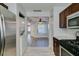 Modern kitchen features stainless steel appliances, laundry closet, and tile flooring at 1550 Jamielinn Ln # 102, Las Vegas, NV 89110