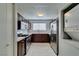 Functional kitchen featuring wooden cabinets, stainless steel appliances, and an in-unit washer and dryer at 1550 Jamielinn Ln # 102, Las Vegas, NV 89110