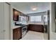 Well-lit kitchen features stainless steel appliances, wooden cabinets, and light countertops at 1550 Jamielinn Ln # 102, Las Vegas, NV 89110