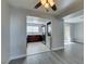 Bright living space features gray wood floors, an opening to a modern kitchen with appliances and laundry at 1550 Jamielinn Ln # 102, Las Vegas, NV 89110