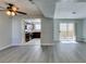Open-concept living area with ceiling fan, view to the kitchen, and sliding doors to the outside at 1550 Jamielinn Ln # 102, Las Vegas, NV 89110