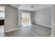 Inviting living room features wood-style floors, natural light, and access to the private balcony at 1550 Jamielinn Ln # 102, Las Vegas, NV 89110
