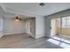 Spacious living room with view to the kitchen, a ceiling fan, and sliding glass doors at 1550 Jamielinn Ln # 102, Las Vegas, NV 89110