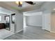 Open living area with gray wood floors leading to kitchen with stainless steel appliances and a laundry area at 1550 Jamielinn Ln # 102, Las Vegas, NV 89110