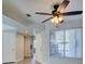 Bright living room featuring updated floors, a ceiling fan, and a window with natural light at 1550 Jamielinn Ln # 102, Las Vegas, NV 89110