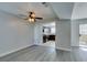 Open living space features hardwood-style floors and a glimpse into the kitchen and balcony at 1550 Jamielinn Ln # 102, Las Vegas, NV 89110