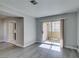 A view of the living room with wood floors and sliding glass doors to balcony at 1550 Jamielinn Ln # 102, Las Vegas, NV 89110