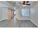 The open living area features hardwood floors, a ceiling fan and natural light at 1550 Jamielinn Ln # 102, Las Vegas, NV 89110