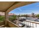 Balcony view overlooking the parking area, landscaping, and other residential buildings at 1881 W Alexander Rd # 2079, North Las Vegas, NV 89032