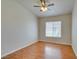 Well-lit bedroom features neutral walls, a ceiling fan and hardwood floors at 1881 W Alexander Rd # 2079, North Las Vegas, NV 89032
