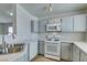 An open kitchen features white cabinets, and a stainless-steel sink at 1881 W Alexander Rd # 2079, North Las Vegas, NV 89032