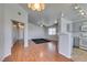 A combined living and kitchen area boasts an open design, hardwood floors, and gray walls at 1881 W Alexander Rd # 2079, North Las Vegas, NV 89032