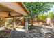 Backyard featuring covered patio, stone pavers, playset, and mature landscaping at 189 Regal Sunset Ave, Henderson, NV 89002