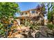 Spacious backyard featuring mature trees, a covered patio, and outdoor play equipment at 189 Regal Sunset Ave, Henderson, NV 89002