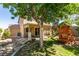 Expansive backyard featuring a covered patio, play structure, mature trees, and custom stone pathway at 189 Regal Sunset Ave, Henderson, NV 89002