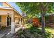 Spacious backyard featuring mature trees, playset, covered patio, and hardscape at 189 Regal Sunset Ave, Henderson, NV 89002