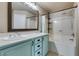 Bathroom featuring dual sinks, a bathtub with shower, and a framed mirror at 189 Regal Sunset Ave, Henderson, NV 89002