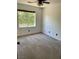 Carpeted bedroom featuring a window for natural light and a ceiling fan for comfort at 189 Regal Sunset Ave, Henderson, NV 89002