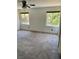 Spacious bedroom with neutral carpet, dual windows, and a ceiling fan at 189 Regal Sunset Ave, Henderson, NV 89002