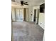 Large bedroom featuring neutral carpet, ceiling fan, and patio access with curtains at 189 Regal Sunset Ave, Henderson, NV 89002