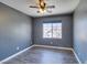 Cozy bedroom featuring wood floors, ceiling fan, and ample natural light at 189 Regal Sunset Ave, Henderson, NV 89002