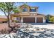 Inviting two-story home featuring a three-car garage and desert landscaping at 189 Regal Sunset Ave, Henderson, NV 89002