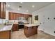 Charming kitchen with stainless appliances, dark wood cabinets, and granite countertops at 189 Regal Sunset Ave, Henderson, NV 89002