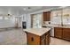 Open kitchen island with granite counters, stainless steel appliances, and tile floors at 189 Regal Sunset Ave, Henderson, NV 89002