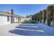 A beautifully landscaped backyard featuring gravel, artificial grass, and manicured trees at 1943 Hallwood Dr, Las Vegas, NV 89119
