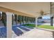 Entertain in this backyard featuring covered patio, artificial turf, and mature privacy landscaping at 1943 Hallwood Dr, Las Vegas, NV 89119