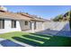 Backyard patio with artificial grass and brick flooring at 1943 Hallwood Dr, Las Vegas, NV 89119