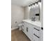 Updated bathroom with a white vanity, black hardware, and a modern vanity light fixture at 1943 Hallwood Dr, Las Vegas, NV 89119