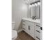Modern bathroom with white cabinets, black hardware, and stylish vanity lighting at 1943 Hallwood Dr, Las Vegas, NV 89119