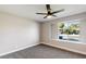 Cozy bedroom with carpet, a ceiling fan, and a window with neighborhood views at 1943 Hallwood Dr, Las Vegas, NV 89119