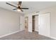 This bedroom features neutral walls, carpet floors, a ceiling fan, and a closet with sliding doors at 1943 Hallwood Dr, Las Vegas, NV 89119
