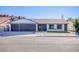Charming single-story home featuring a three-car garage, brick accents, and manicured landscaping at 1943 Hallwood Dr, Las Vegas, NV 89119