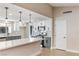 Well-lit kitchen with island seating, stainless appliances, and sleek white and gray cabinetry at 1943 Hallwood Dr, Las Vegas, NV 89119