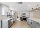 Bright, modern kitchen featuring white and gray cabinets, stainless steel appliances, and quartz countertops at 1943 Hallwood Dr, Las Vegas, NV 89119