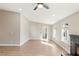 Open-concept living room featuring light-filled windows and a charming fireplace at 1943 Hallwood Dr, Las Vegas, NV 89119