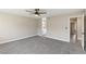 This spacious primary bedroom features neutral walls, carpet floors, a ceiling fan, and an ensuite bath at 1943 Hallwood Dr, Las Vegas, NV 89119