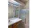 Full bathroom with a shower-tub combo, large mirror, wooden vanity, and tiled walls at 2050 N Los Feliz St # 114, Las Vegas, NV 89156