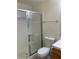 Full bathroom featuring a glass enclosed shower, white toilet, and wooden vanity at 2050 N Los Feliz St # 114, Las Vegas, NV 89156