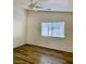 Bedroom featuring wood floors, a ceiling fan, and a window with blinds at 2050 N Los Feliz St # 114, Las Vegas, NV 89156