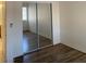 This bright bedroom features wood floors and a mirrored closet at 2050 N Los Feliz St # 114, Las Vegas, NV 89156
